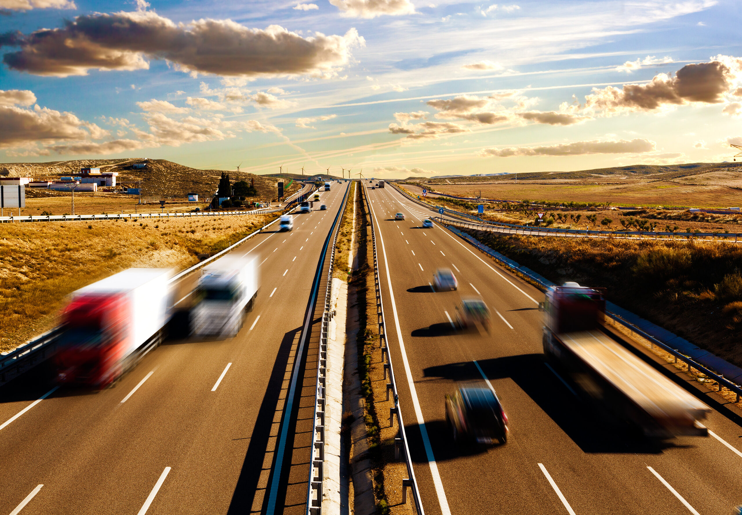 Highway with many moving cars and trucks