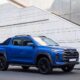 LDV T60 double cab bakkie with a black alloy frame and wheels driving on a road.