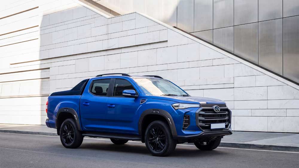 LDV T60 double cab bakkie with a black alloy frame and wheels driving on a road.