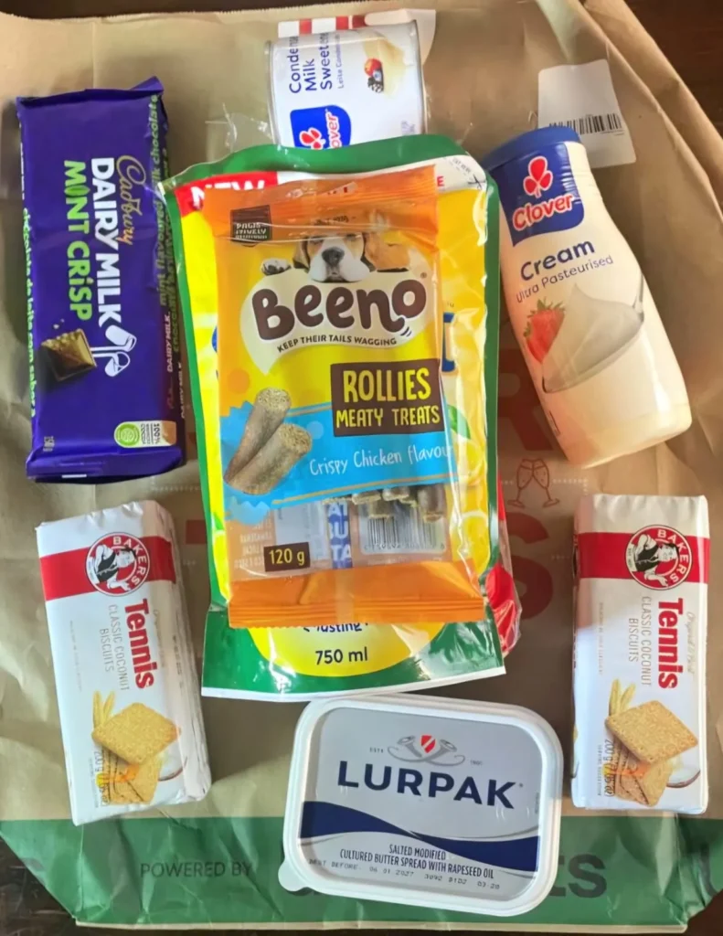Uber Eats order on a table with the groceries lying face down displaying the variety of good ordered.