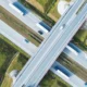 Aerial shot of a bustling highway with freight trucks transporting goods.