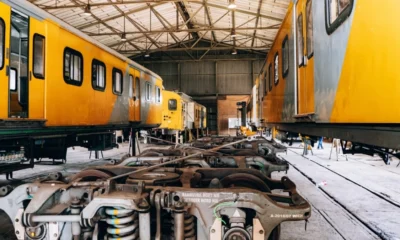 South African yellow and grey trains parked in a service yard.