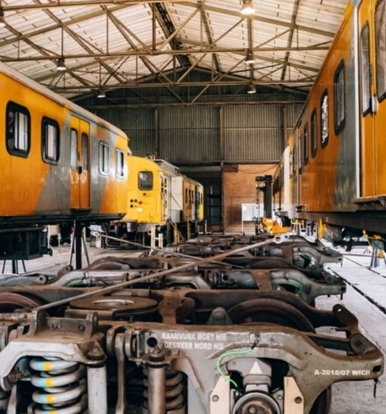 South African yellow and grey trains parked in a service yard.