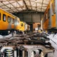 South African yellow and grey trains parked in a service yard.
