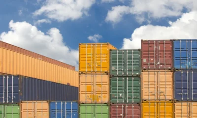 Shipping yard with stacked containers.
