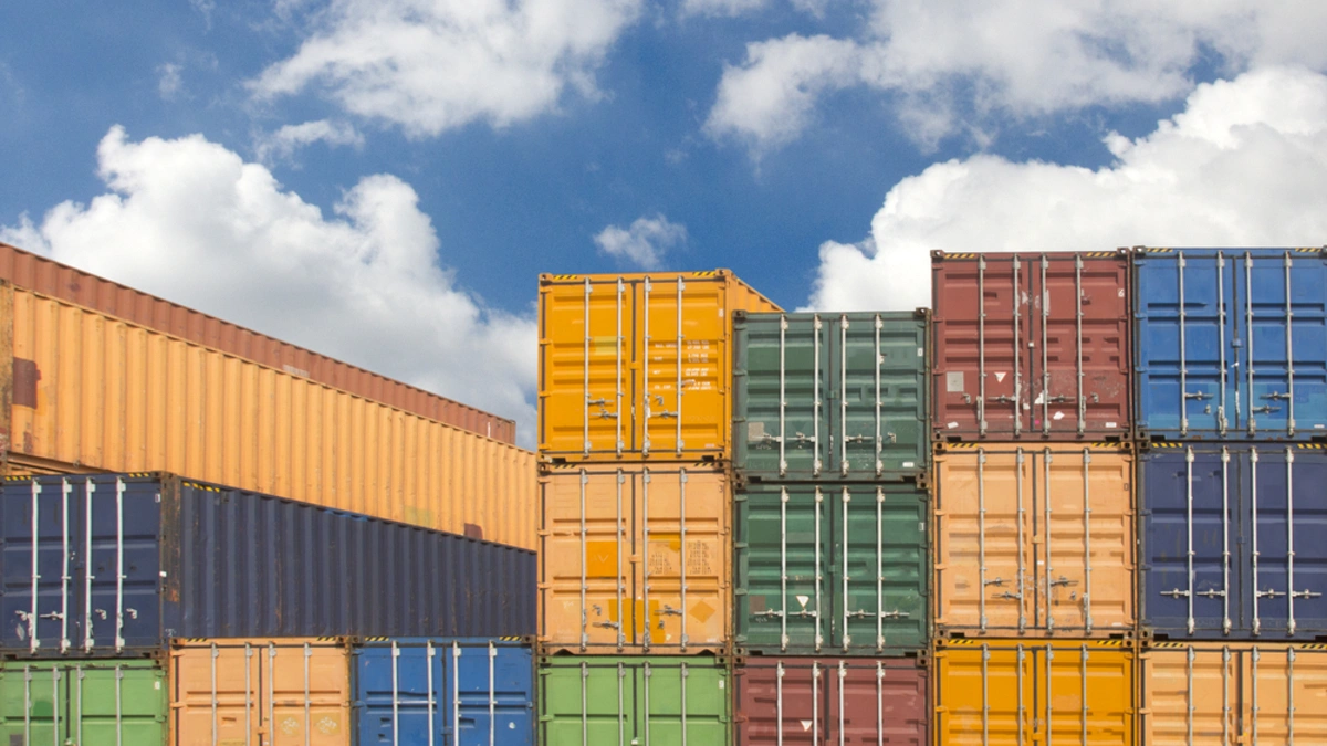 Shipping yard with stacked containers.
