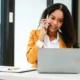 Supply chain leader on a business call in front of her laptop.