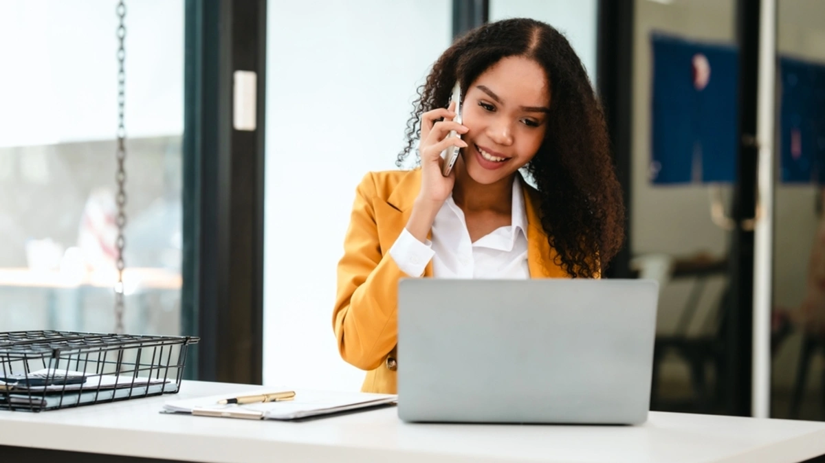 Supply chain leader on a business call in front of her laptop.