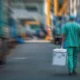 Focused shot of a surgeon in scrubs walking away in scrubs carrying a cooler with life-saving treatment.