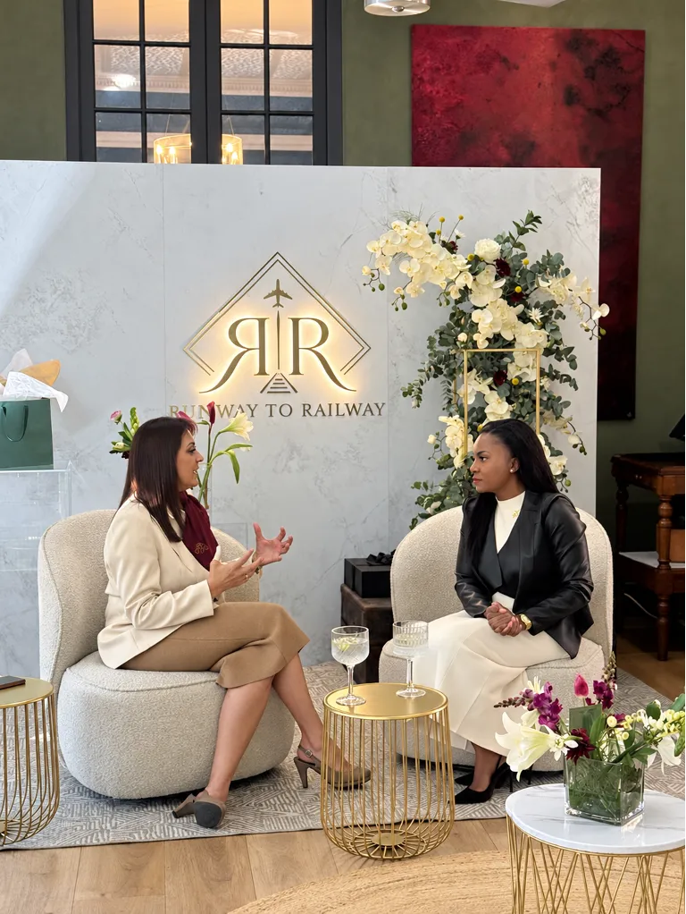 Two women networking in a lounge area at the Runway to Railway conference.
