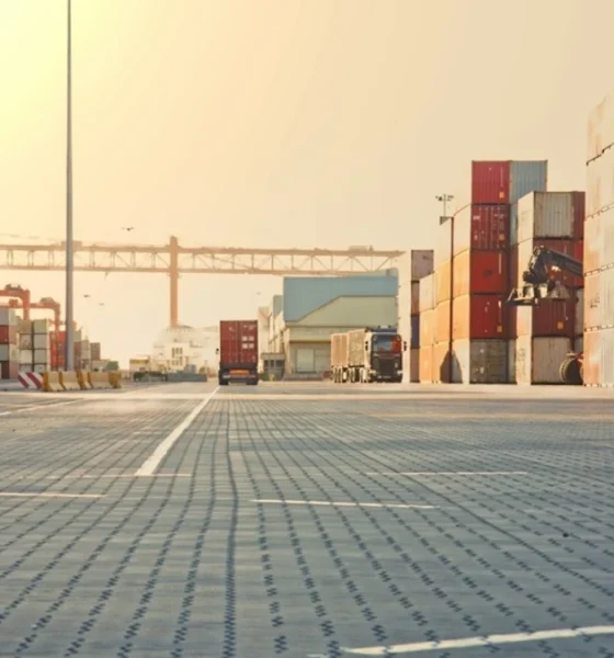 Freight truck unloading cargo in a shipping yard.