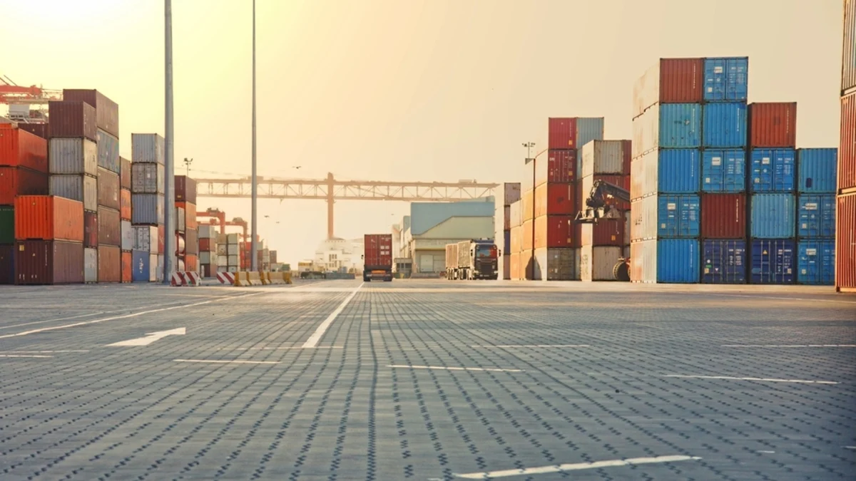 Freight truck unloading cargo in a shipping yard.