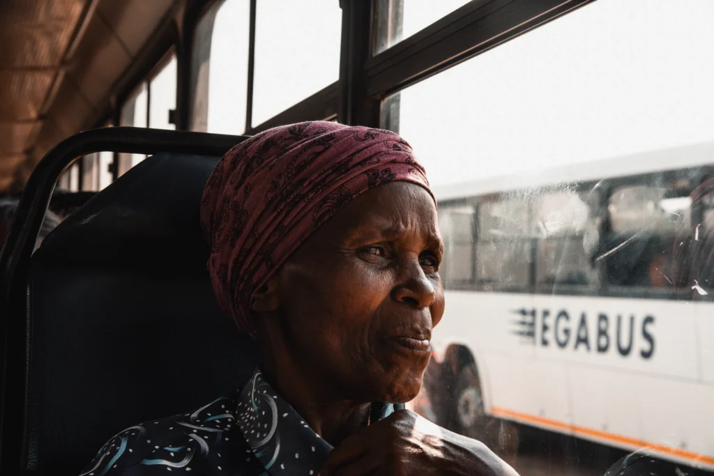 Elderly woman sitting on the bus.