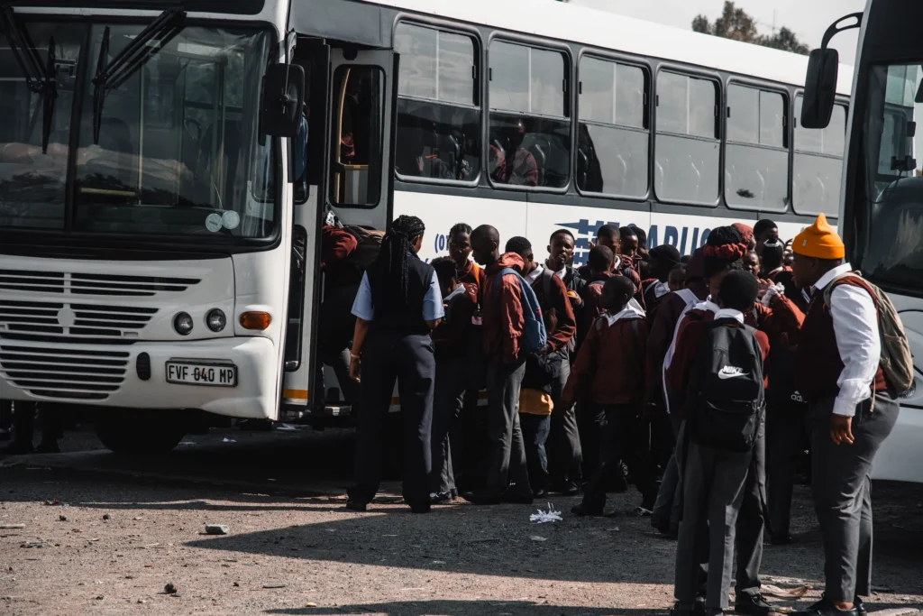 School children boarding the bus.
