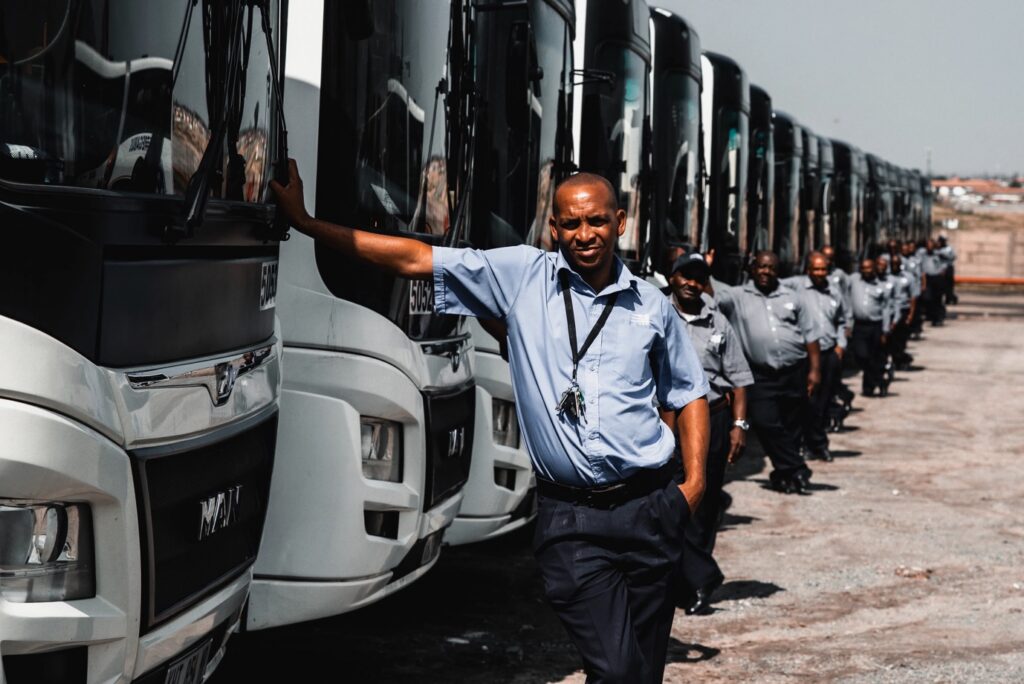 Megabus bus drivers posing next to their buses.