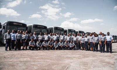 Unitrans team posed in front of their busses.