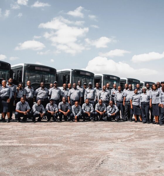 Unitrans team posed in front of their busses.