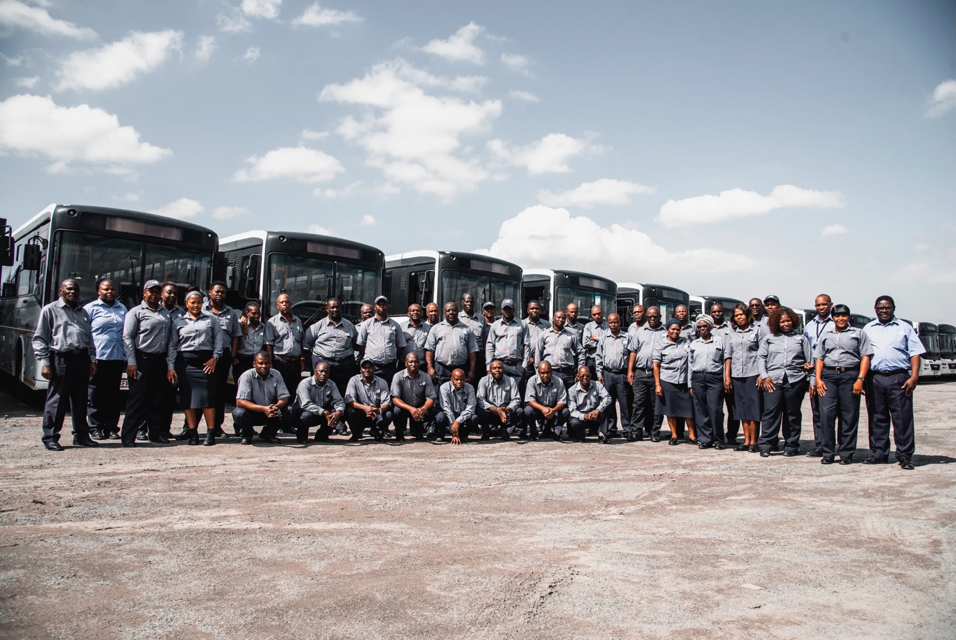 Unitrans team posed in front of their busses.